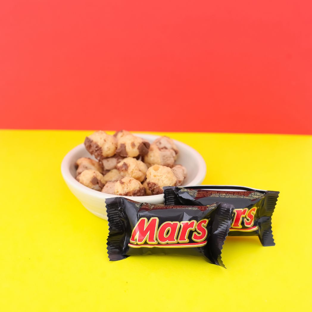 Mars bar with a bowl of cookies on a red and yellow background