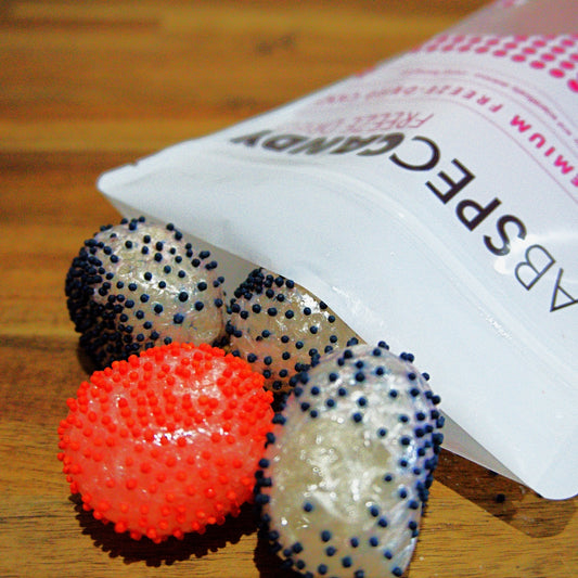 round candy balls with little balls that are red and purple freeze dried and by lab spec candy