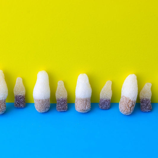 Row of colorful candy sticks on a blue and yellow background